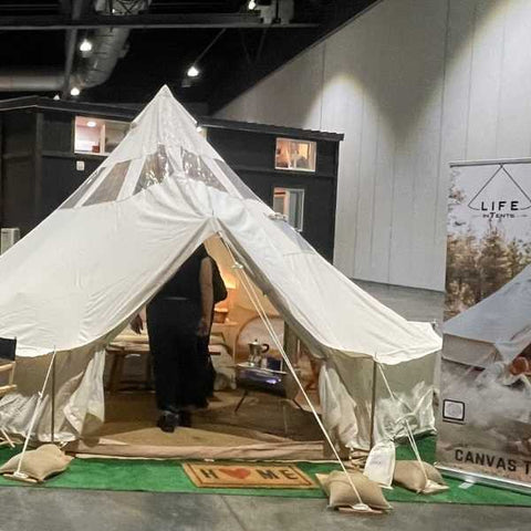 bell tent setup at a tradeshow inside