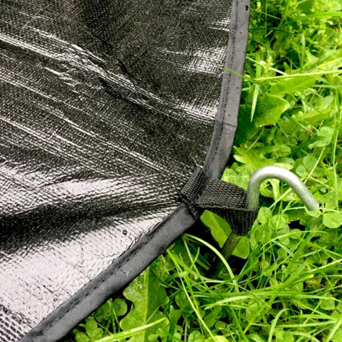 tent footprint staked into grass